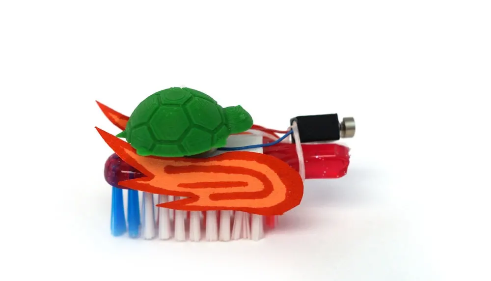 toy turtle on a brush bot with flames