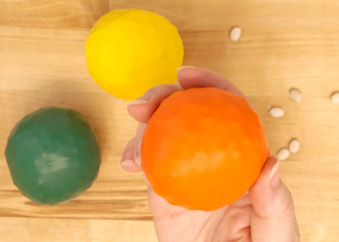 bean balls made of balloons in orange, yellow and green