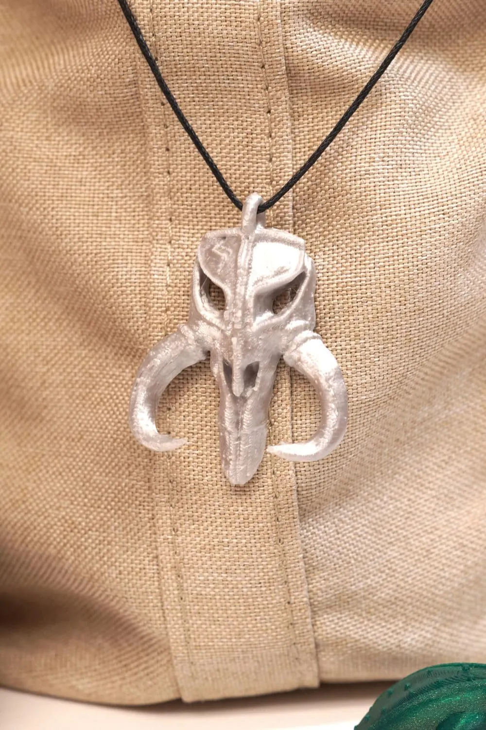 baby yoda's Mythosaur pendant