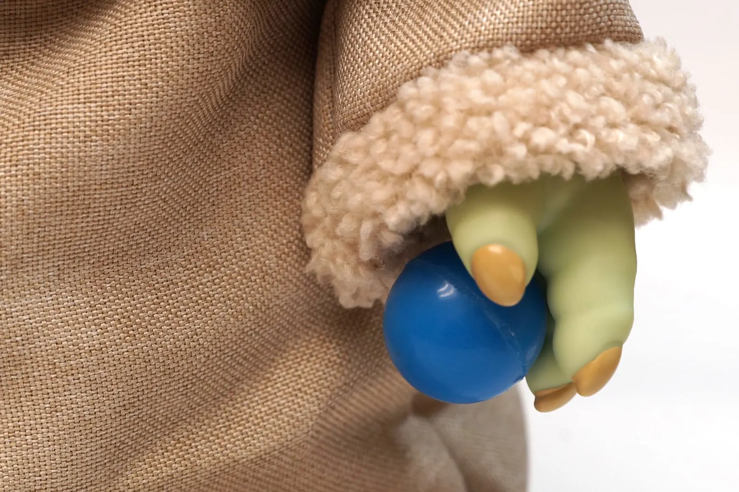 Blue super ball in Baby Yoda doll's hand