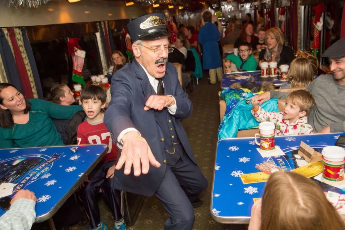 Mr. Conductor entertains kids on the St. Louis Polar Express train ride