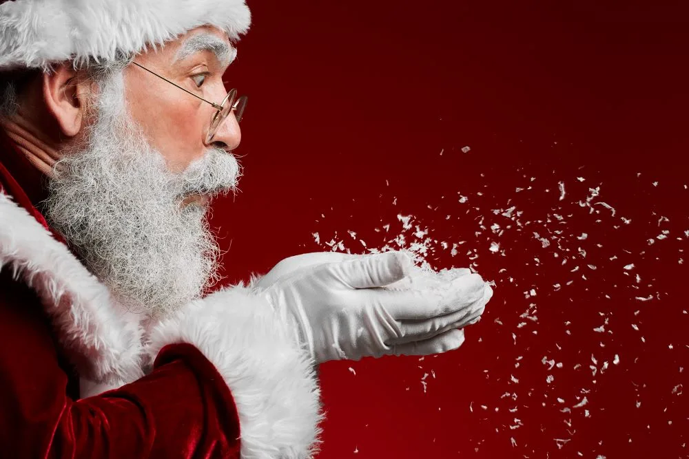 santa blowing snow from his hands