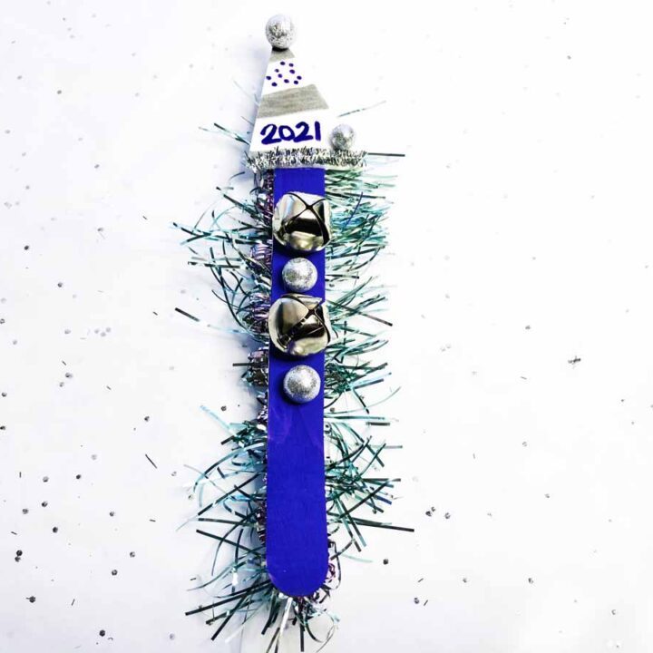 popsicle stick noise maker in blue with jingle bells