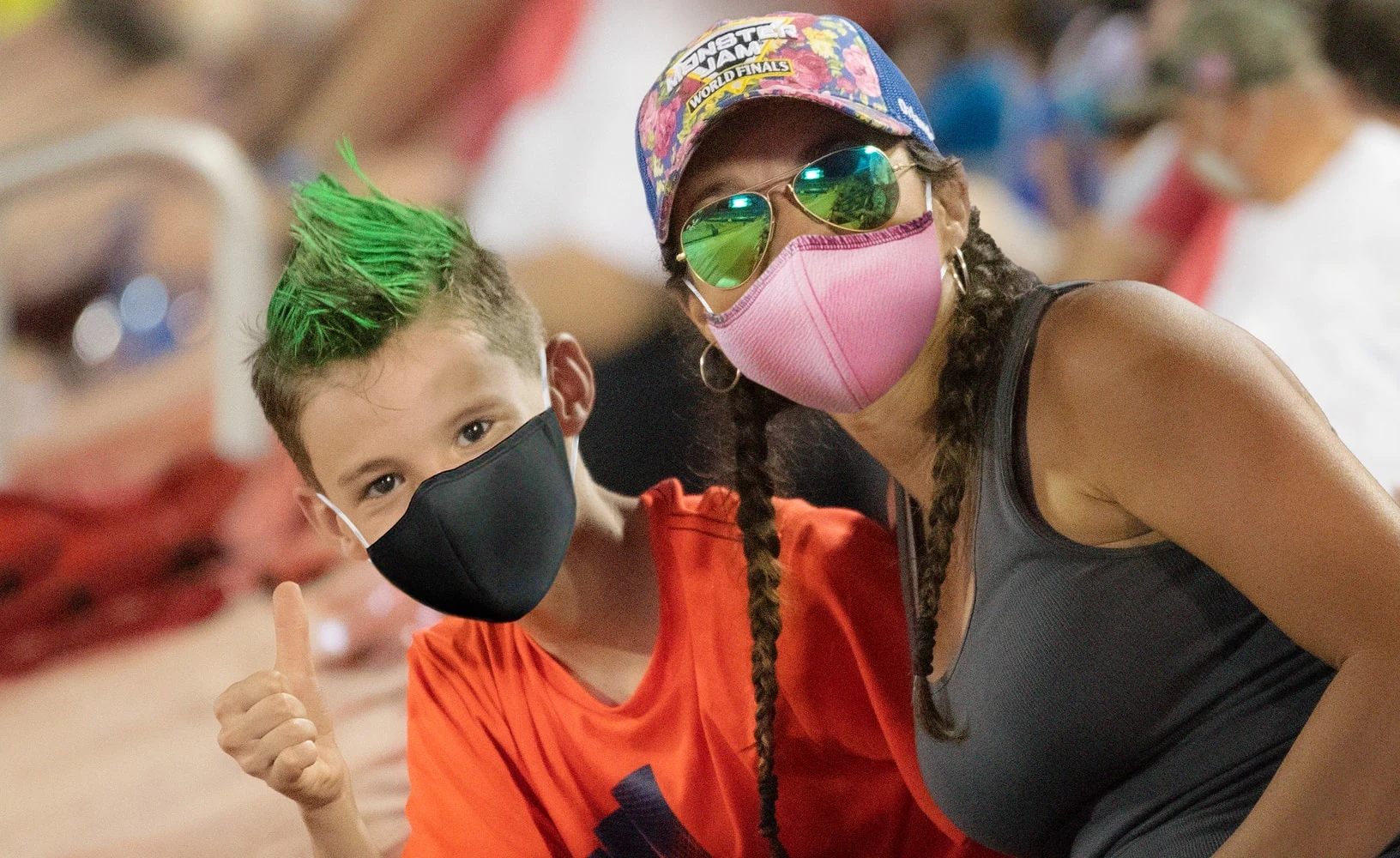 monster jam fans, mom and son in masks