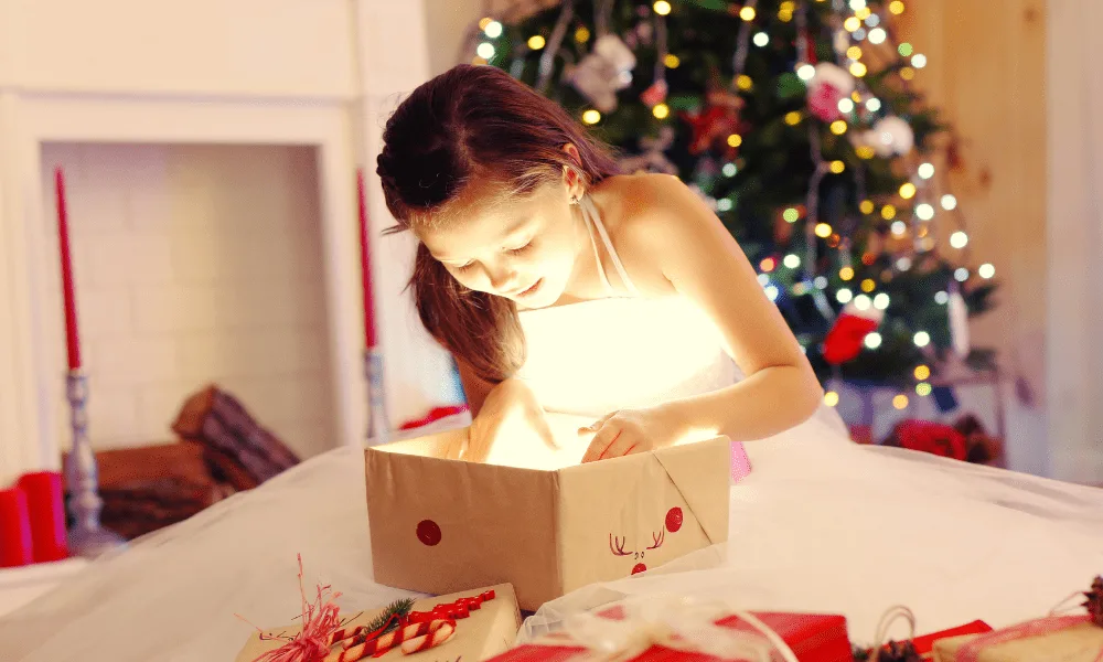 girl opening gift with light inside