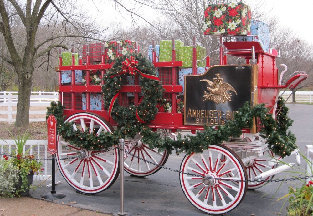 red horse wagon from Anheuser-Busch decorated for Christmas and full of gift wrapped boxes