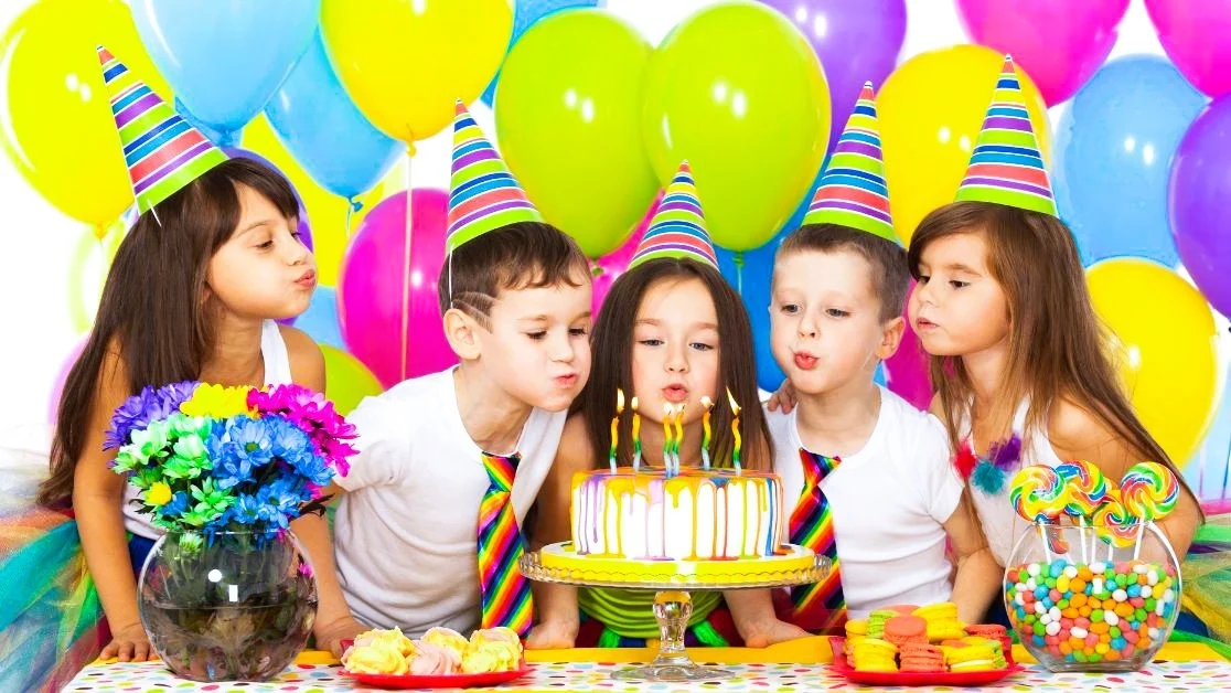 kids at the best birthday party with cake and balloons