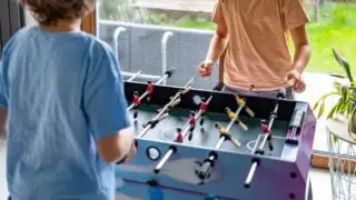 Two Boys play Foosball