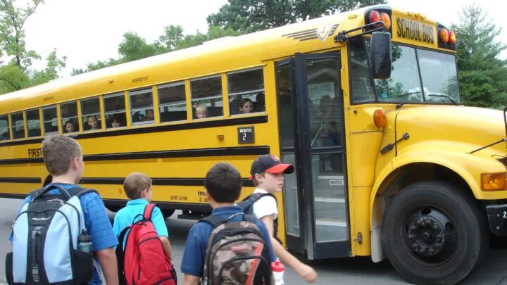 kids getting on the school bus