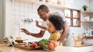 Dad and kid cooking together